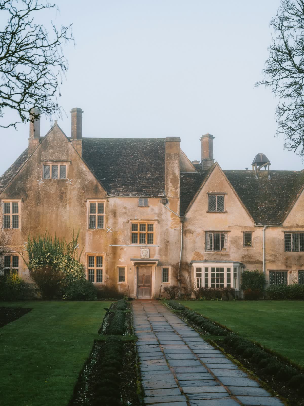 A stone house with a garden path