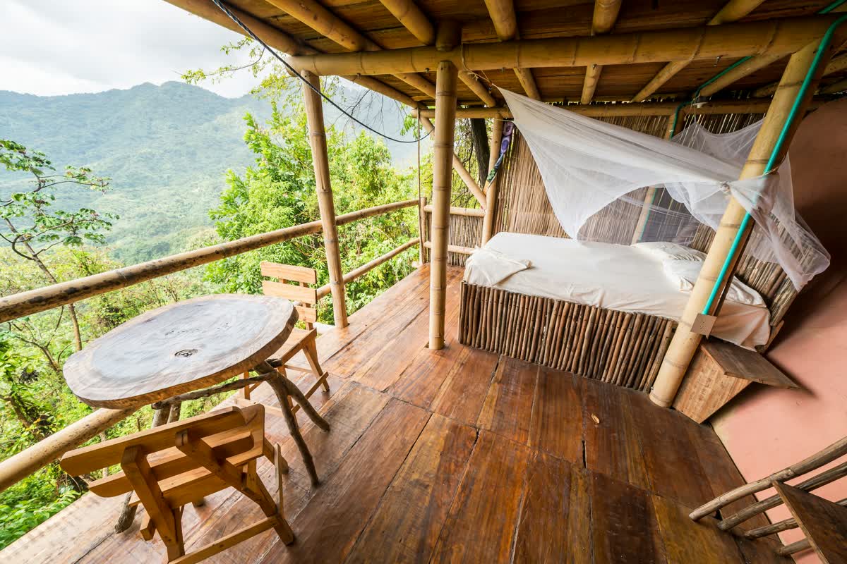 A bamboo lodge overlooking green mountains
