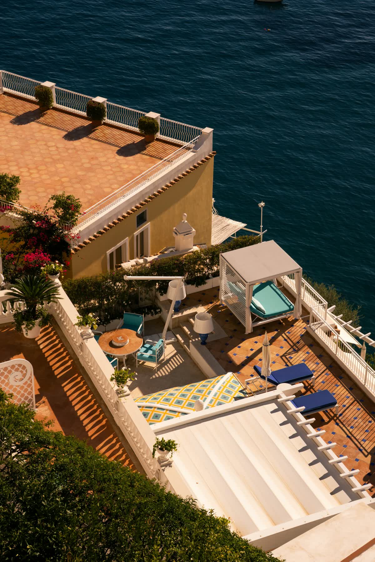 A villa terrace with an ocean view and lounge seating